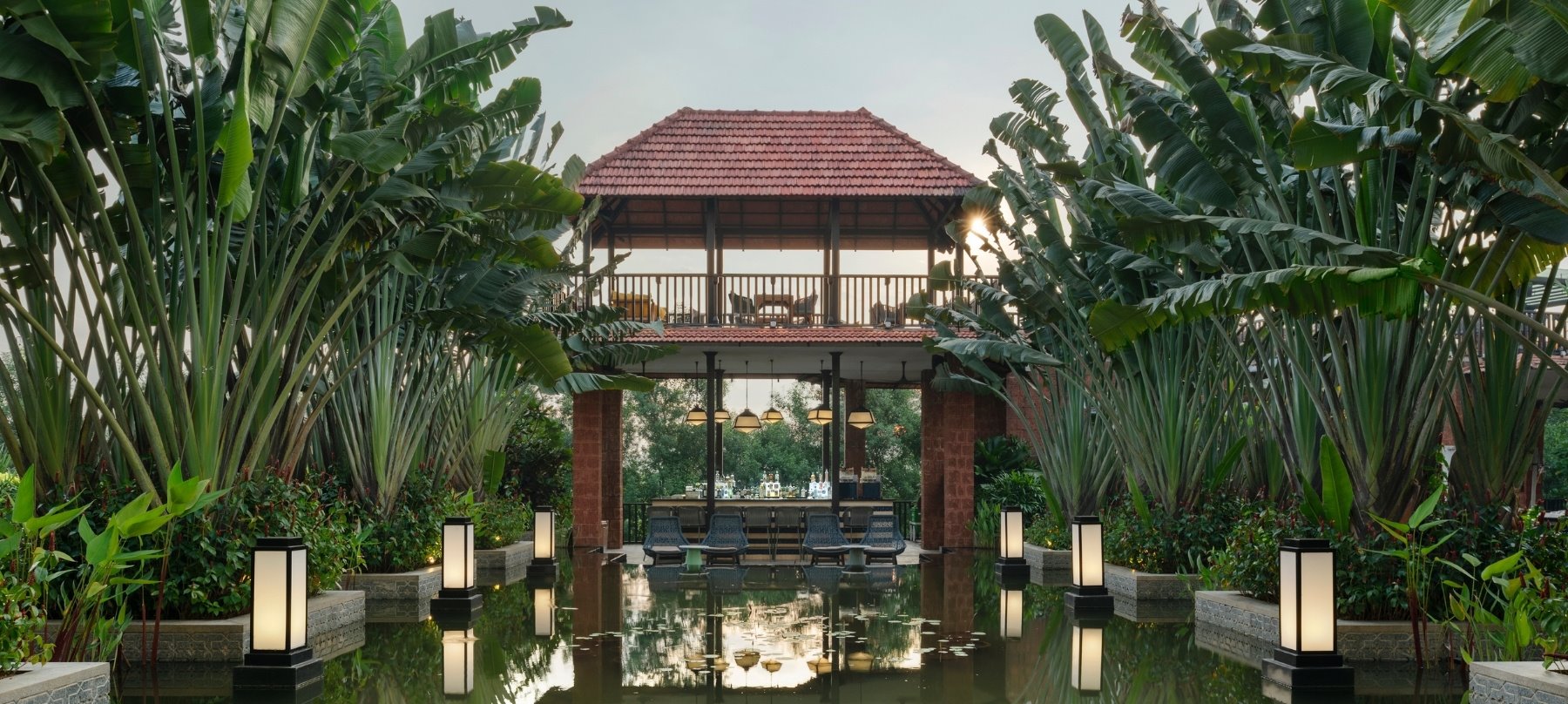 Outdoor dining with pond and greenery in Anjuna Goa